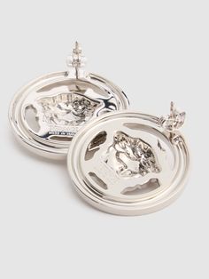 two silver dishes with animals on them