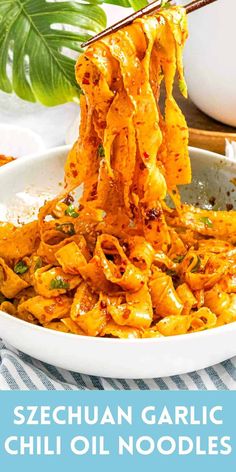 garlic chilli noodles being lifted from a bowl with chopsticks