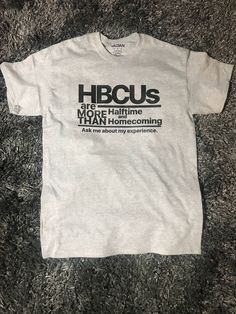 HBCU More than Halftime and Homecoming Shirt - HBCU Grad. Choice of two designs! Design 1 is shorter phrase. Design 2 is longer phrase. 100% cotton Preshrunk T-shirt. Available in sizes S-3x. Unisex shirts. Women's v-neck and fitted available. S-XL. Standard shirt colors are black, white, and gray. Leave a note with size. Text is available in white, gold, red, orange, new gold, frost clear, orange, green, blue, yellow, navy blue, maroon, rose gold, silver, gray, and others. Please indicate text Pre-shrunk Gray Cotton Shirt, Cotton Slogan T-shirt Fan Apparel, Cotton Slogan T-shirt For Fan Apparel, Cotton Slogan T-shirt For Fans, Cotton Fan Apparel T-shirt With Slogan, Gray Cotton Shirt With Graphic Print, Cotton Fan Apparel Shirt With Letter Print, Casual Shirt With Funny Text For Fans, Hbcu Grad