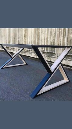 three metal and glass tables sitting on the ground