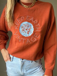 "Upcycled vintage rust colored oversized sweatshirt with baby blue Keep Earth Vintage logo embroidered by small, woman-owned embroidery artist. By purchasing this item, you are supporting a small business, a local embroidery artist and saving a piece of clothing from potentially ending up in a landfill or incinerator while receiving a one-of-a-kind sweatshirt! 50% cotton | 50% polyester | M Recommended for size S-XL depending on desired drape & styling but please always refer to measurements as Vintage Crew Sweater With Embroidered Logo, Retro Embroidered Sweatshirt For Fall, Retro Fall Sweatshirt With Embroidered Logo, Retro Sweatshirt With Embroidered Logo For Fall, Brown Long Sleeve Sweatshirt With Embroidered Logo, Vintage Long Sleeve Tops With Embroidered Text, Vintage Oversized Brown Sweatshirt, Oversized Vintage Brown Sweatshirt, Vintage Embroidered Crew Sweatshirt