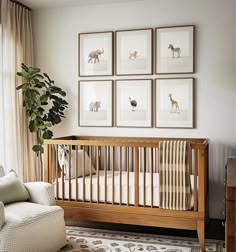 a baby's room with four framed pictures on the wall and a crib