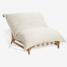 a small wooden chair with a pillow on it