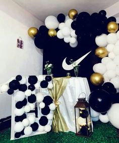 black and white balloons are on display in the room