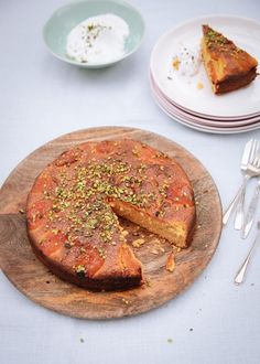 there is a cake on the wooden plate