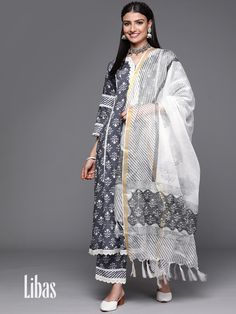 Our 3-piece grey printed Cotton suit set features a A-line floral print kurta with a notched neckline and contrasting fabric and lace-trim accents on the yoke and sleeves, straight palazzo pants with a partially elasticated waistband and roomy pockets, and a complementing dupatta. Ideal pick for effortless everyday wear. #GulByLibas #LibasSpringSummer22 #LibasIndia #Libas #IndianWear #PrintedKurta #CottonKurta #FloralKurta #IndianWear #EthnicWear #AlineKurta Straight Palazzo Pants, Delicate Pearl Jewelry, Carnival Dress, Dress Neck, Printed Kurti