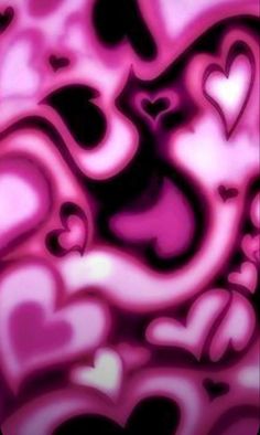 some pink and black hearts in the middle of a wallpaper pattern, with one heart on it's left side