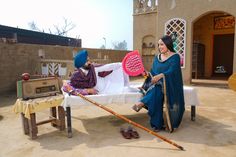 two women sitting on a table with tennis rackets