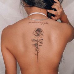 a woman with a rose tattoo on her back