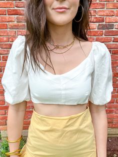 Look stunning in the Elsa Tie Back Bubble Sleeve Top. This cute and stylish crop top pairs perfectly with high-waisted skirts for a complete vacation look. It features eye-catching puff sleeves and tie-back details that add a unique and fashionable touch. Elastic backing with tie closure Elastic sleeve cuffs Puff sleeves 70% cotton 30% linen Lined 100% cotton Stylist Review: •Model is 5’5” with a 32” bust and wearing a size Small. Fits True To Size. Summer V-neck Crop Top For Brunch, Summer Crop Top With Short Sleeves For Day Out, Casual Summer Cropped Puff Sleeve Top, Casual Cropped Puff Sleeve Top For Summer, Summer Vacation Puff Sleeve Top With Short Sleeves, Summer Vacation Puff Sleeve Short Sleeve Top, Summer Vacation Puff Sleeve Top, Fitted Puff Sleeve Crop Top For Summer, Summer Casual Puff Sleeve Top For Brunch