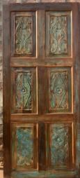 an old wooden door with glass panels on it