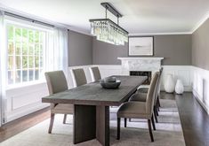 a dining room table with chairs and a chandelier