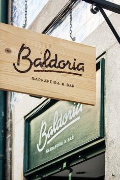 a sign hanging from the side of a building that reads balderia garrafira x bar