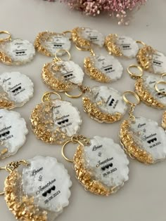 white and gold key chains with names on them