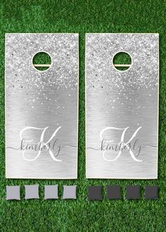 two personalized metal cornhole tossers on green grass