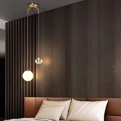 a bed sitting in a bedroom next to a wall with lights hanging from it's sides