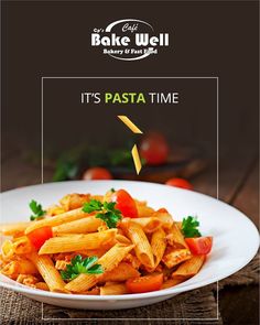 a white plate filled with pasta and vegetables on top of a wooden table next to an advertisement