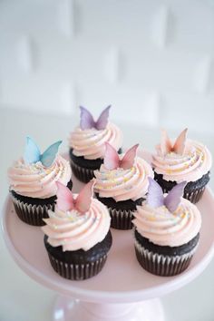 cupcakes with pink frosting and butterflies on top