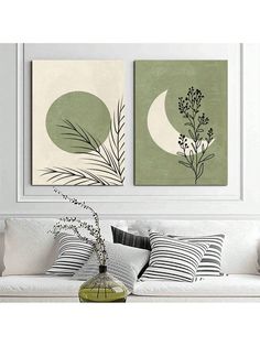 two paintings on the wall above a couch with pillows and plants in front of it