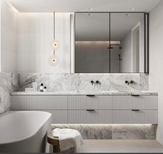 a bathroom with marble counter tops and white bathtub next to a large mirror on the wall