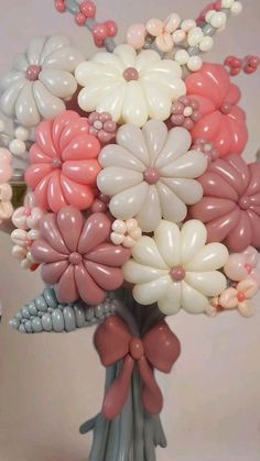 a vase filled with lots of balloons and flowers