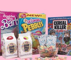 various cereals and milk are displayed on a pink background, with two boxes of cereal in the foreground