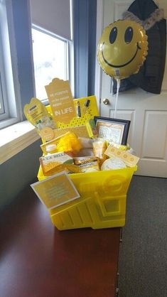 a yellow box filled with lots of different items sitting on top of a wooden table