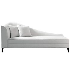 a white couch with two pillows on it's back and one arm folded up