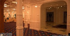 the inside of a building with columns, lights and rugs on the carpeted floor