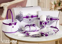 a table topped with white and purple items