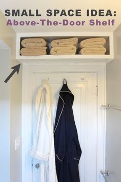 an open door with towels hanging on the shelf above it and two folded white towels in front of them