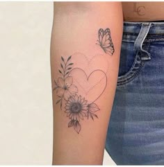 a woman's arm with a heart and flowers tattoo on the left side of her arm