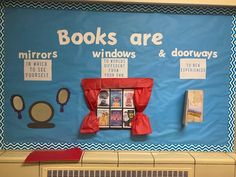 a bulletin board with books are displayed on the wall