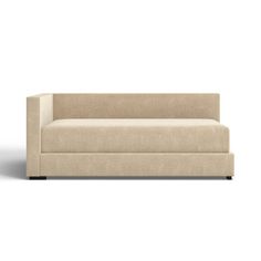 a beige couch sitting on top of a white floor