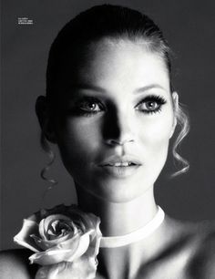 black and white photograph of a woman with rose in her hair