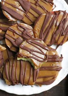 a white plate topped with cookies covered in chocolate