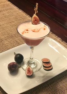 a dessert is served on a plate with figs