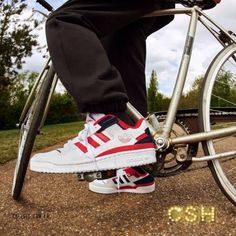 a person riding a bike with their feet on the handlebars