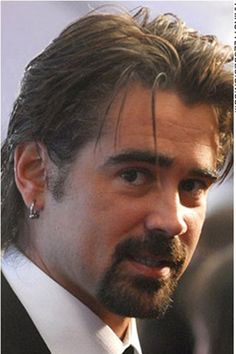 a close up of a person in a suit and tie with a goatee on