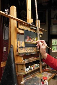 a woman is painting in an art studio