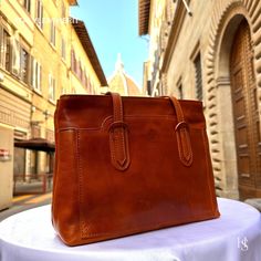 "This bag has been made of the best genuine leather by local master crafters of Florence in Italy, designed for women who only accept premium Italian quality and luxury leather bags and modern Italian fashion. . Sizes: Width: 30 cm / 11.8 inches Height: 23 cm / 9.1 inches Depth: 11 cm / 4.4 inches The story of this bag: Once upon a time, in the picturesque city of Florence, Italy, a group of skilled artisans embarked on a journey to create a remarkable handmade leather bag that would epitomize the essence of Italian craftsmanship. Their dedication and expertise gave birth to a brown bag that exuded timeless elegance and unmatched quality. Handcrafted with meticulous attention to detail, this Italian leather bag was a testament to the artisans' unwavering commitment to their craft. The soft Business Shoulder Bag In Vegetable Tanned Leather, Business Vegetable Tanned Leather Shoulder Bag, Elegant Vegetable Tanned Leather Shoulder Bag For Everyday Use, Elegant Everyday Shoulder Bag In Vegetable Tanned Leather, Formal Vegetable Tanned Leather Shoulder Bag, Luxury Vegetable Tanned Leather Shoulder Satchel, Classic Cognac Shoulder Bag In Vegetable Tanned Leather, Classic Vegetable Tanned Leather Shoulder Bag, Classic Cognac Vegetable Tanned Leather Shoulder Bag