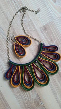 a multicolored necklace is hanging on a chain