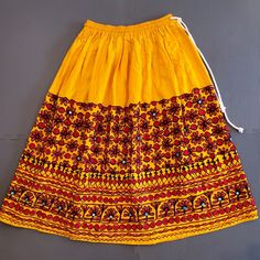 Hand Embroidered, Draw String And Elastic Waist, Skirt Custom Designed By Fashion Apparel In India Traditional Yellow Bottoms For Festive Occasion, Traditional Long Skirt For Summer, Traditional Long Summer Skirt, Festive Yellow Long Skirt, Traditional Lined Skirt For Summer, Traditional Summer Lined Skirt, Festive Traditional Skirt With Floral Embroidery, Traditional Long Yellow Skirt, Traditional Cotton Lined Skirt