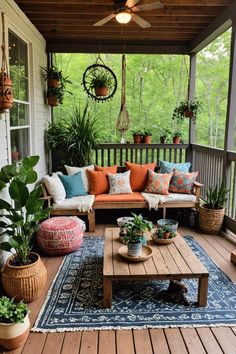 a covered porch with lots of plants and couches on top of the wooden floor