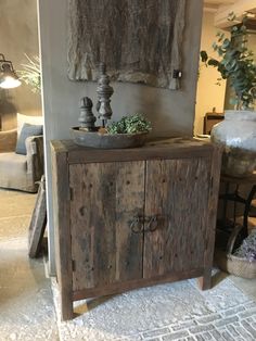 a wooden cabinet sitting in the middle of a living room