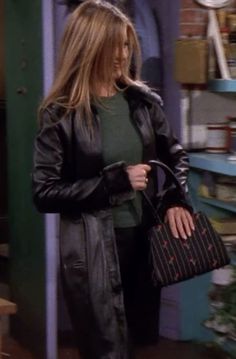 the young woman is holding her purse and looking at another person's handbag