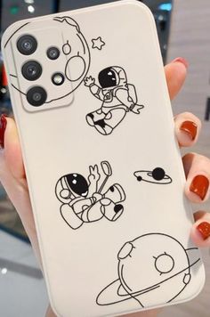 someone holding up their phone case with drawings on it