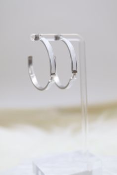 The White Luxury H Hoop Silver Earrings showcase a contemporary H-shaped hoop design, beautifully crafted from polished silver. They are elegantly accented with pristine white embellishments, enhancing their sophisticated and luxurious appeal. Size: 40 mm Closure: Butterfly Earring Backs Material: Brass with Silver Plating with Rhodium Coating Lead Free and Hypoallergenic Hoop Silver Earrings, Butterfly Earring, Hoop Design, Butterfly Earrings, Tennis Bracelet, Earring Backs, Christmas Sale, Rainbow Colors, Medium Size