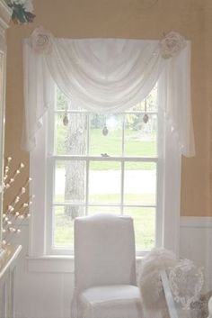 a white chair sitting in front of a window