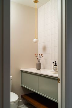 a bathroom with a sink, toilet and mirror